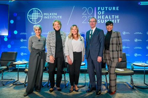 Director Ahuja, far left, poses on stage with four other speakers at the Milken Institute’s Health Summit.